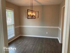 Dallas house for rent - an empty dining room with wood floors and a chandelier