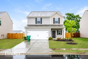 Pendergrass house for rent - A house with a grey roof and a white garage door.