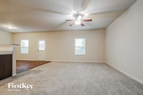 Pendergrass house for rent - A spacious room with a carpeted floor and a ceiling fan.