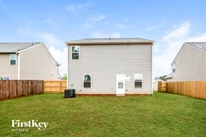 Pendergrass house for rent - A house with a fence and a grassy yard.