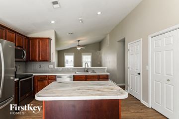 Goose Creek house for rent - a kitchen with a marble counter top in the center of it