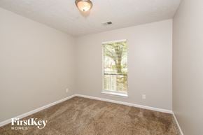 Acworth house for rent - a bedroom with carpet and a large window