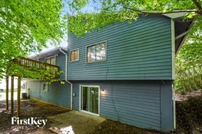 Acworth house for rent - a blue house with blue siding and green trees