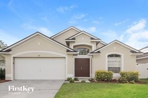 Orlando house for rent - A house with a garage and a brown door.