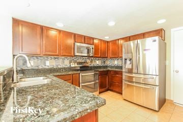 Phoenix house for rent - a kitchen with granite counter tops and stainless steel appliances