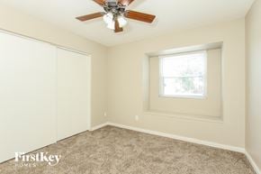 Phoenix house for rent - a bedroom with a ceiling fan and a window