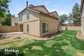 Phoenix house for rent - the back of a house with a yard and grass