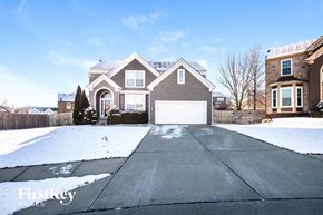 Kansas City house for rent - a view of a street with houses in the snow