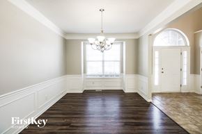 Kansas City house for rent - an empty dining room with a window and a chandelier