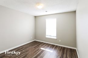 Kansas City house for rent - the living room of an apartment with wood flooring and a window