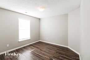 Kansas City house for rent - the upstairs bedroom with hardwood flooring and a window
