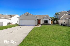 Trenton house for rent - a white house with a garage and a lawn