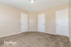 Trenton house for rent - a bedroom with two doors and a carpeted floor