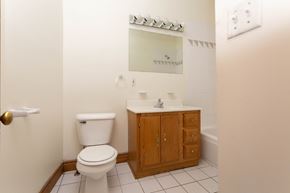 Detroit apartment for rent - A white toilet sits next to a sink in a bathroom.