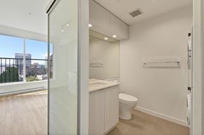 Victoria apartment for rent - A white bathroom with a toilet and a sink.