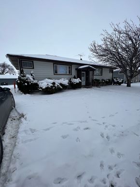 Fargo apartment for rent - A house with a snow covered front yard.