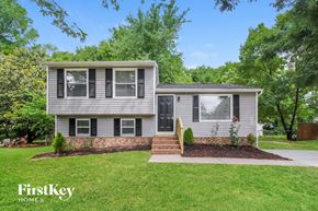 Charlotte house for rent - a home with a lawn and a sidewalk in front of it
