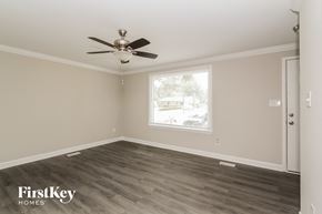 Charlotte house for rent - a living room with wood floors and a ceiling fan