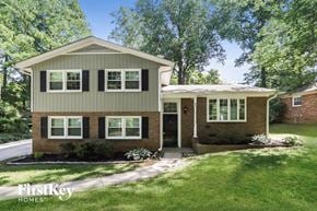 Greensboro house for rent - a home with a green roof and a lawn and trees