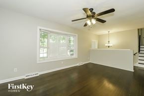 Greensboro house for rent - a living room with wood floors and a ceiling fan
