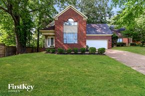 Memphis house for rent - a home with a lawn and a white garage door