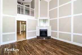 Memphis house for rent - a living room with a fireplace and a wooden floor