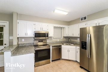 Memphis house for rent - a kitchen with stainless steel appliances and granite counter tops