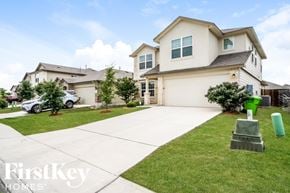 San Antonio house for rent - A large house with a white garage door and a driveway.