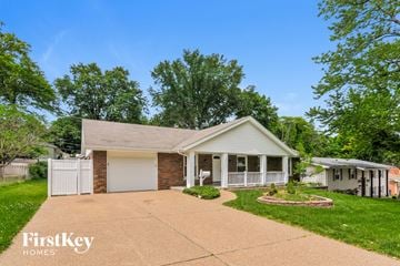Saint Charles house for rent - a white and brick home with a driveway and a white house
