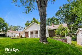 Saint Charles house for rent - a white house with a large tree in the yard