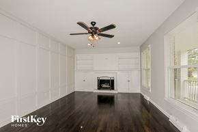 Saint Charles house for rent - a living room with a ceiling fan and a fireplace