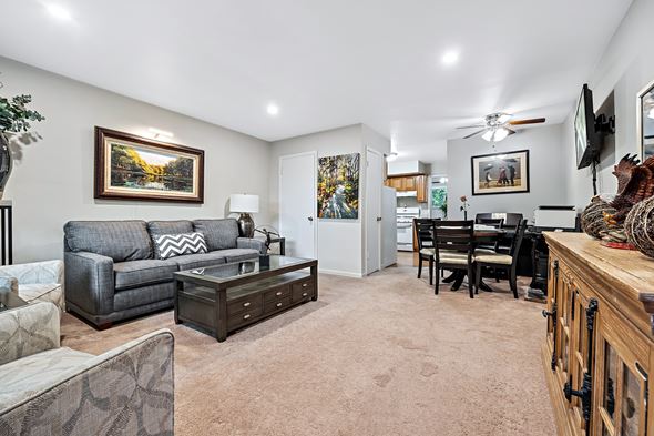 Bensenville apartment for rent - A living room with a grey couch and a painting on the wall.