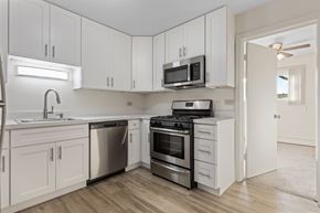 Bensenville apartment for rent - A kitchen with white cabinets and stainless steel appliances.