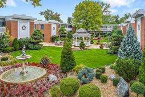 Bensenville apartment for rent - A garden with a fountain and a gazebo.