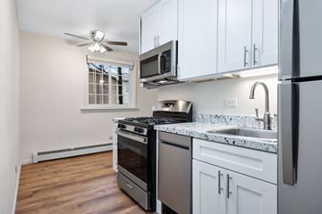 Des Plaines apartment for rent - A kitchen with white cabinets and a stainless steel refrigerator.