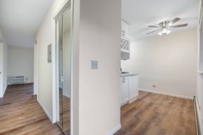 Des Plaines apartment for rent - A room with a ceiling fan and a white cabinet.