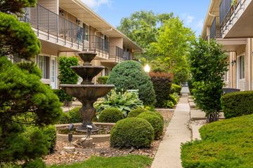 Des Plaines apartment for rent - A fountain in the middle of a well-manicured garden.