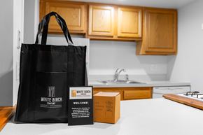 Des Plaines apartment for rent - A black bag with the words White Birch Company on it is on a kitchen counter.