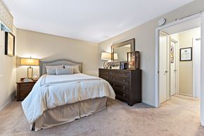 Worth apartment for rent - A bedroom with a large bed and a dresser.