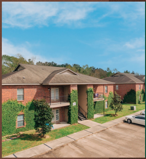 Hammond apartment for rent - the front of a brick house with green ivy and a sidewalk