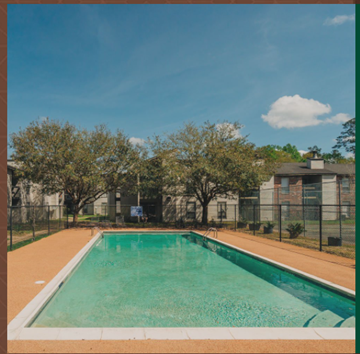 Hammond apartment for rent - a swimming pool with a fence and apartments in the background