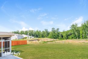 Kernersville house for rent - A grassy field with a fence and trees in the background.