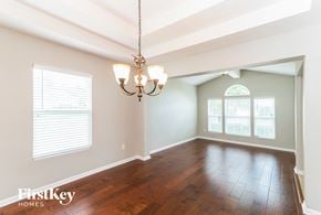 Middleburg house for rent - an empty dining room with wood floors and a chandelier