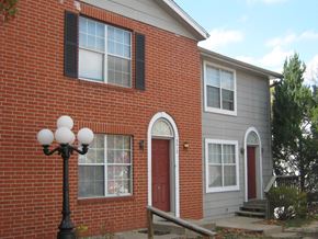 Kansas City townhouse for rent - the side of a brick building with a red door