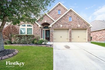 Richmond house for rent - a brick house with a yellow garage door on a driveway