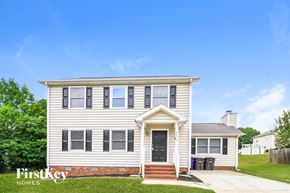 Winston-Salem house for rent - A two-story house with a front porch and a garage door.