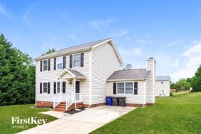 Winston-Salem house for rent - A house with a white exterior and a small porch.