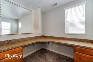 Dublin house for rent - a kitchen with a granite counter top and a large mirror