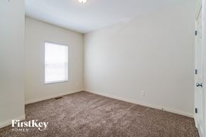 Dublin house for rent - a bedroom with white walls and carpet and a window