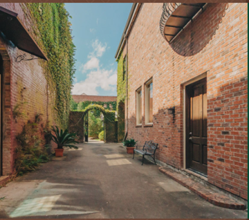 Hammond apartment for rent - a courtyard with a bench and a brick building